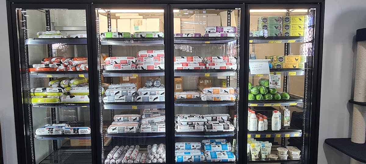 Display shelves filled with dog treats and chews at a pet grooming salon.