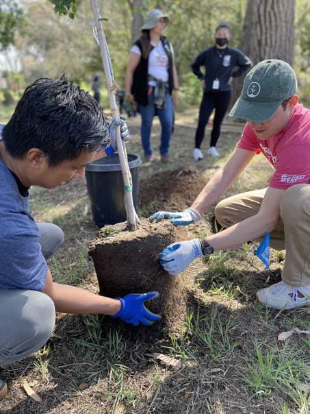 GroupGreeting founder Anthony Doctolero planting a tree with Louis Lagoutte at OneTreePlanted