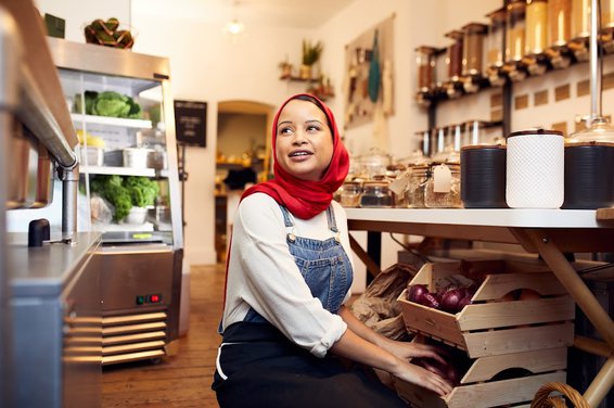 A woman is working on a grocery shop