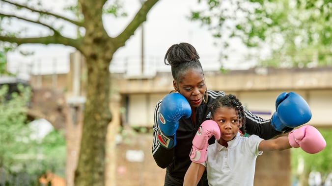 Women-teaching-child-to-box