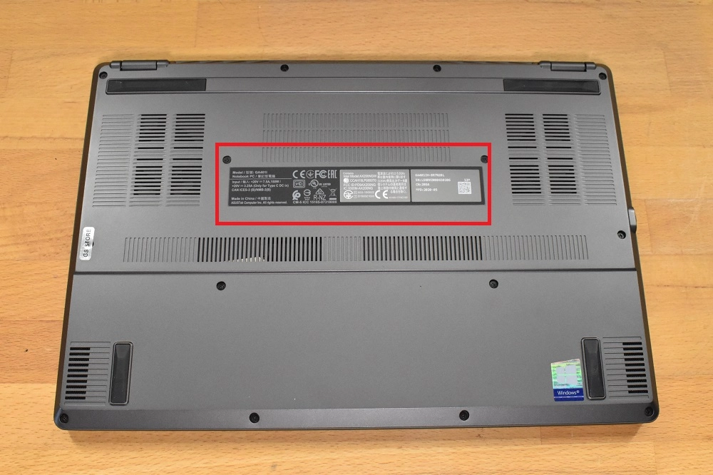 Underside of an Asus laptop showing the model number label