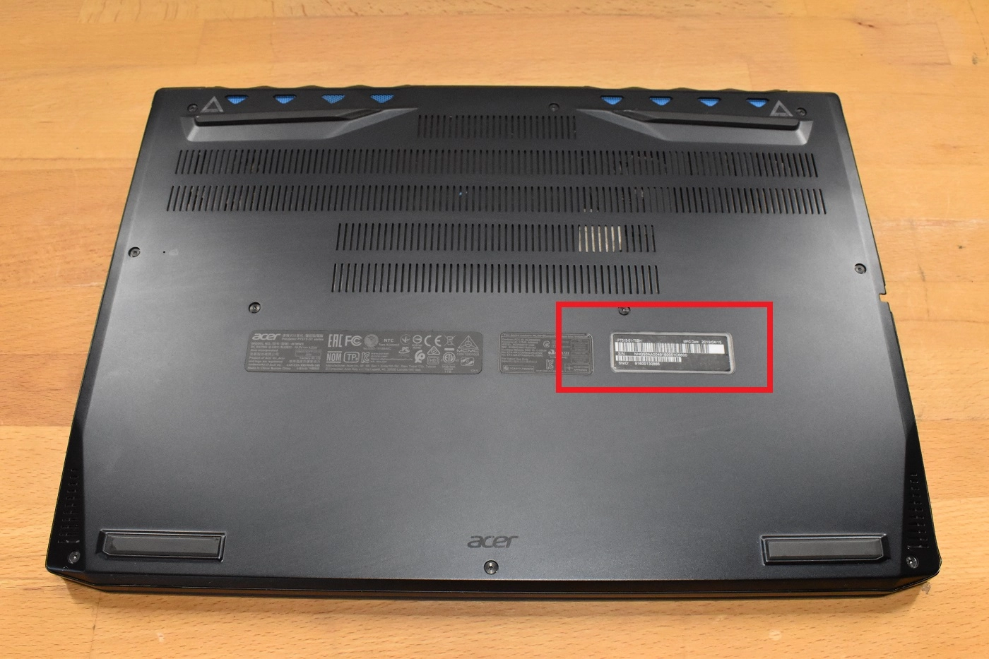 Underside of an Acer laptop showing the model number label