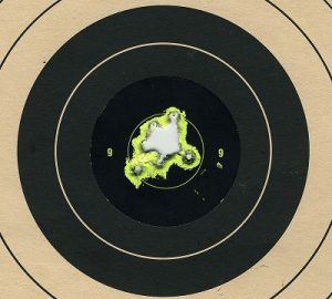 Target with lots of bullet holes in the center