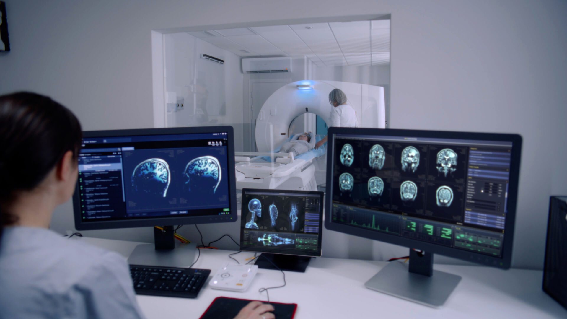 Female radiologist sits in control room and watches at monitors Insurance for Radiologists
