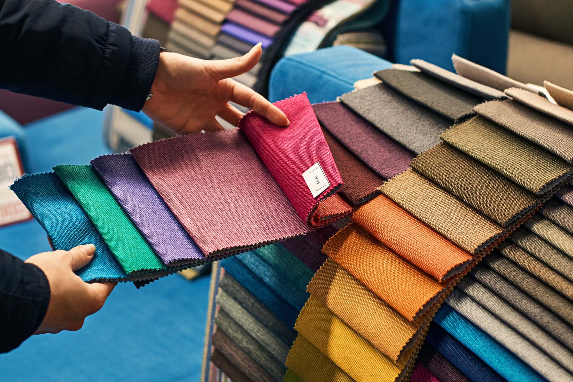 Choosing a fabric color in a store Insurance for Fabric Stores