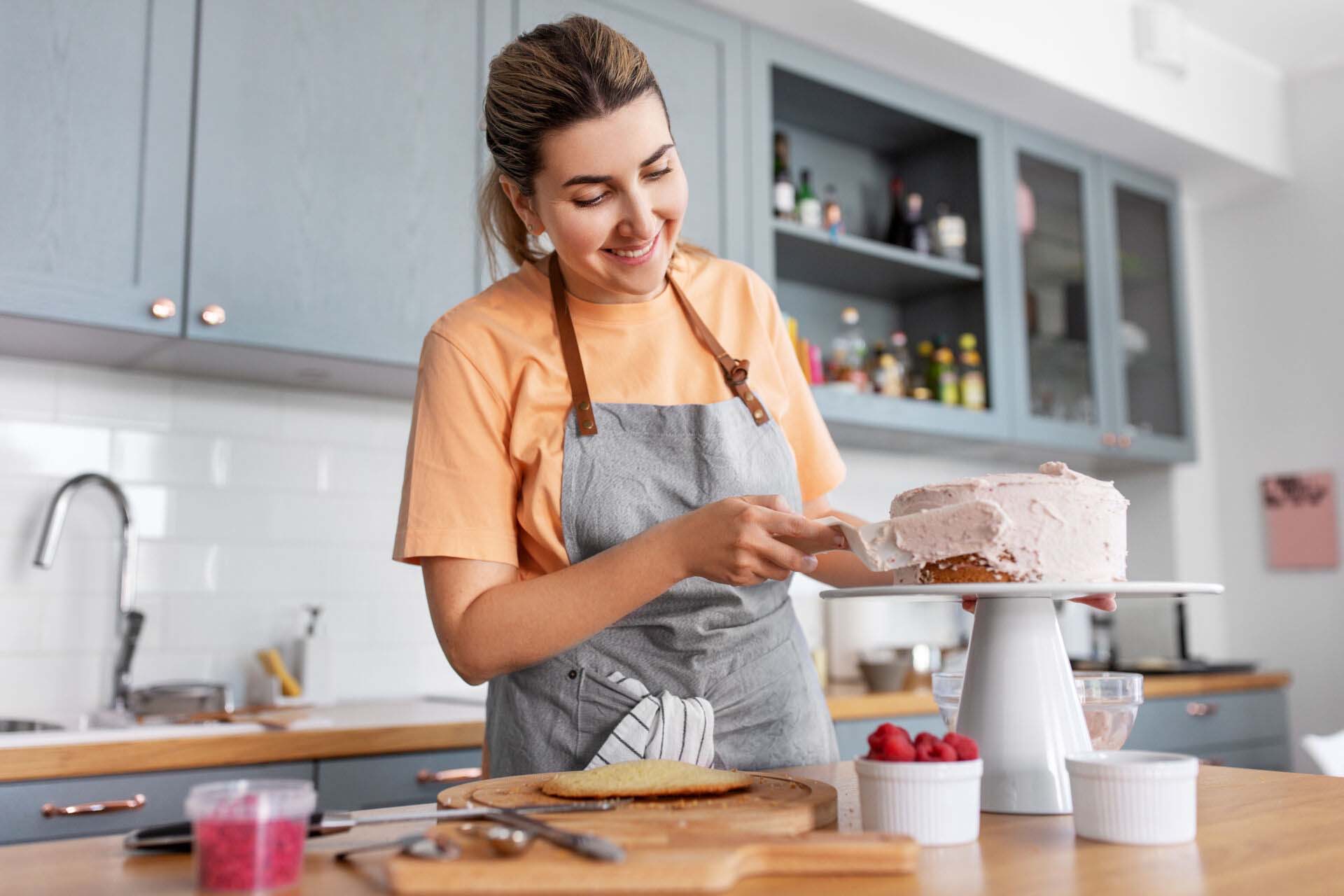 woman cooking food and baking on kitchen at home Insurance for Home Bakers