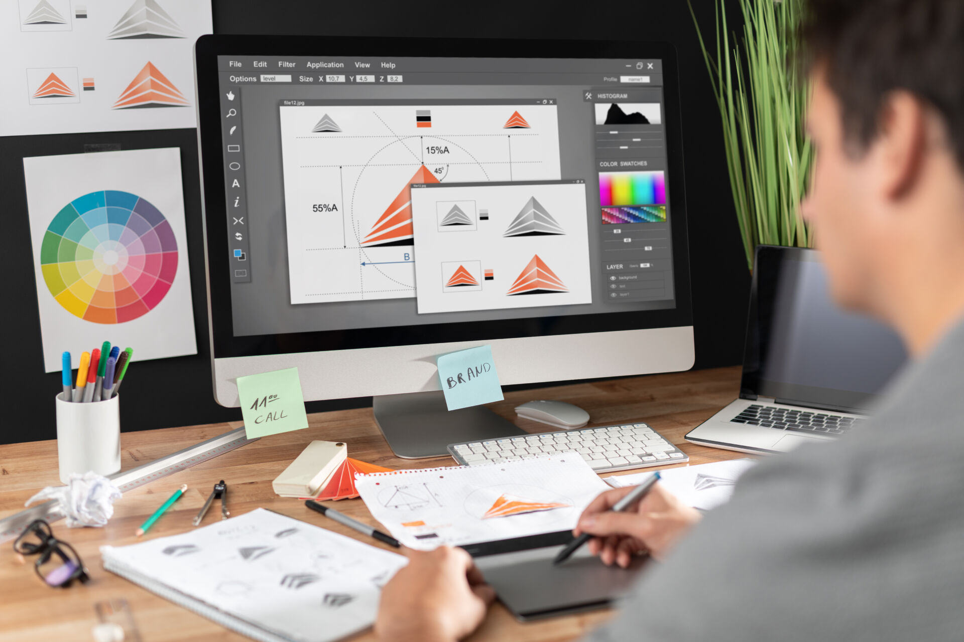 Graphic designer drawing sketches logo design. Insurance for Graphic Designers