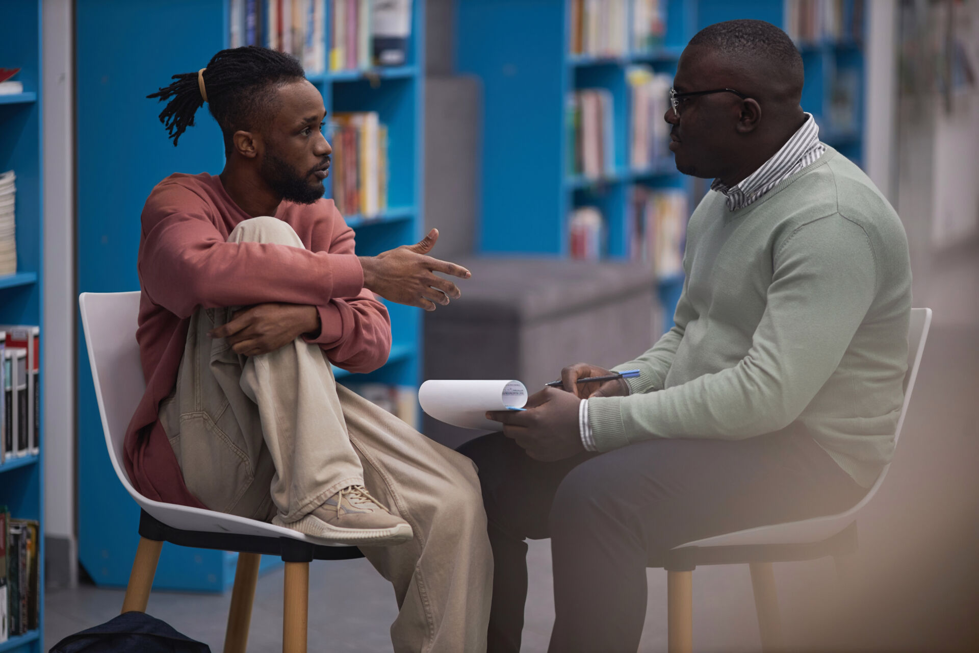 Black student talking to mental health therapist or guidance counselor Insurance for Mental Health Counselors