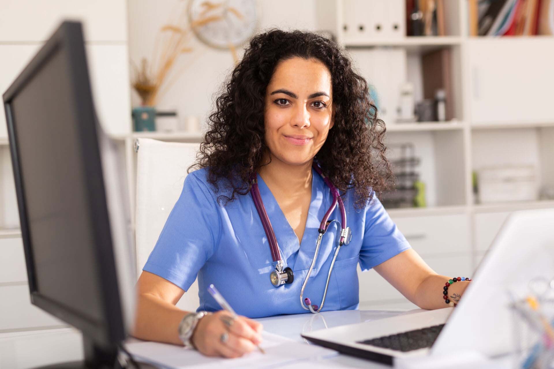 Female doctor working on laptop in office Insurance for Physician Assistants