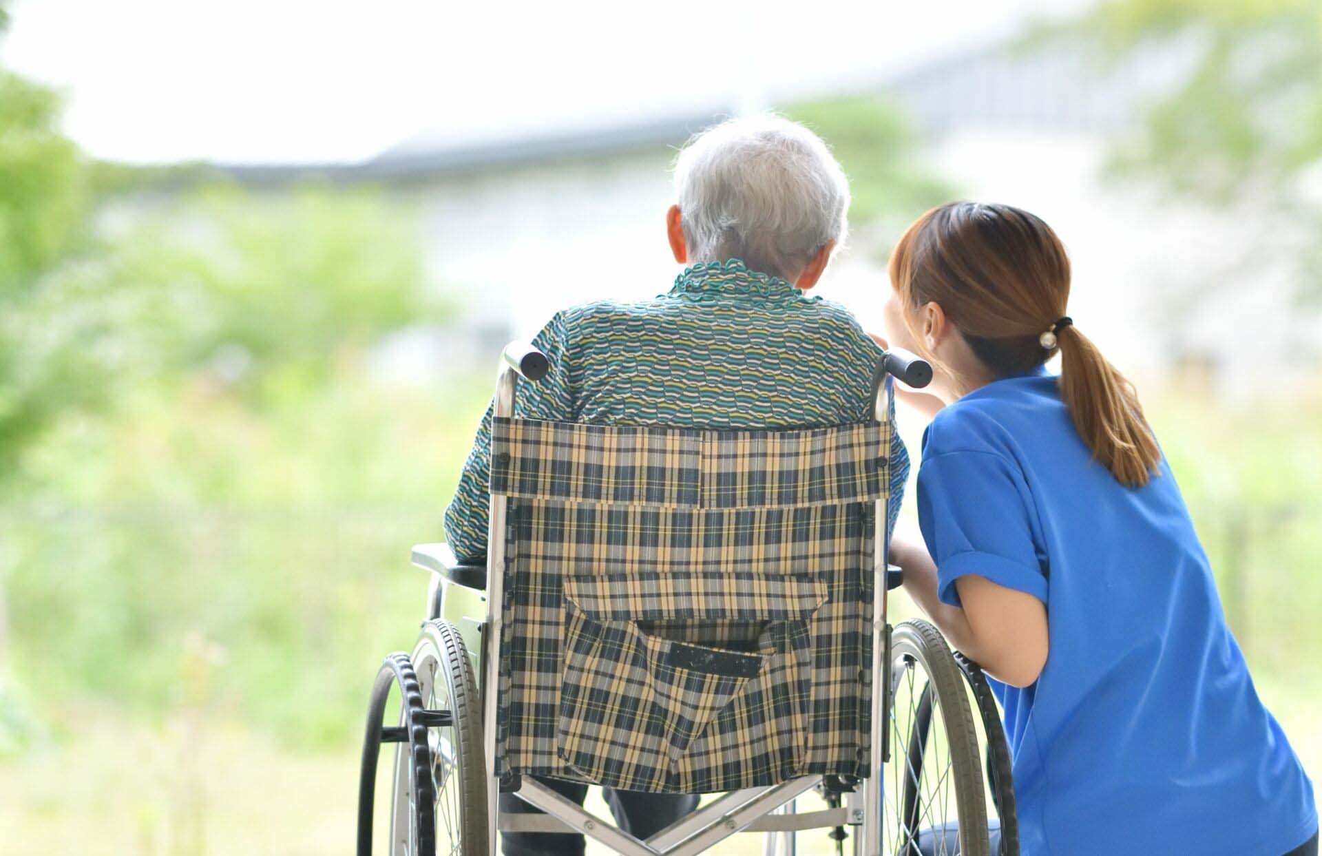 Woman with older man in wheelchair Insurance for Caregivers