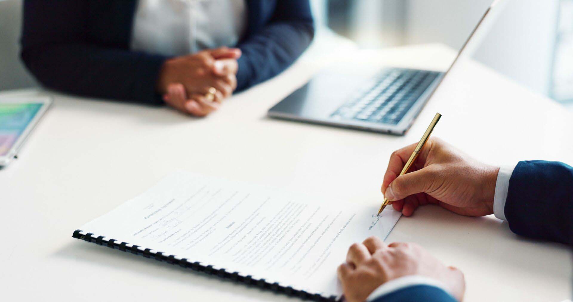 Business hands, legal documents and signature for contract agreement, hiring deal and b2b negotiation. Professional people, lawyers or corporate clients writing of paperwork with terms and conditions Surety Bonds Insurance