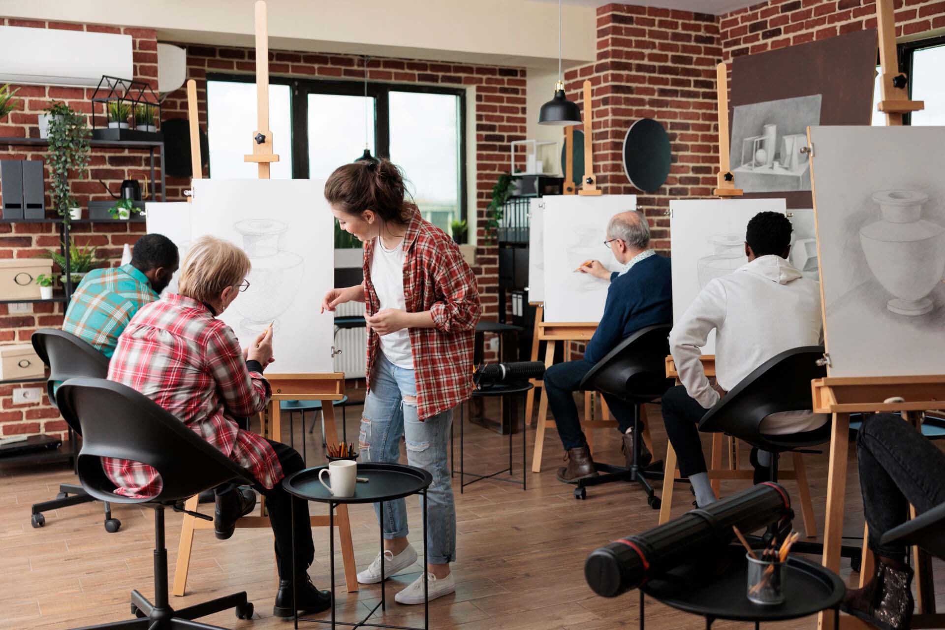 Young teacher helping senior woman to develop illustration technique Human and Social Services