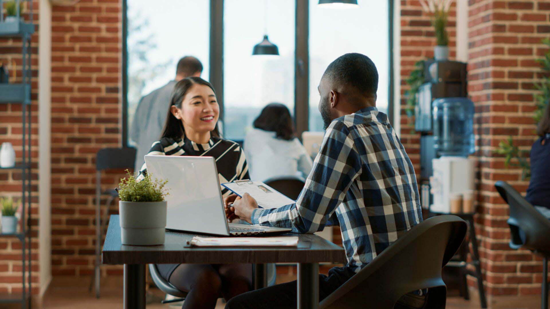 African american recruiter greeting asian woman at job interview Insurance for Recruitment Agencies