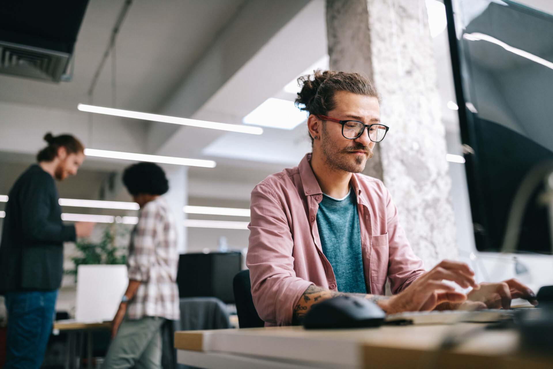 Programmer working and developing software in office Insurance for SaaS Companies