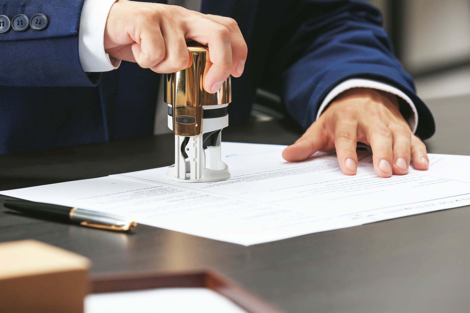 Notary public in office stamping document Insurance for Notaries