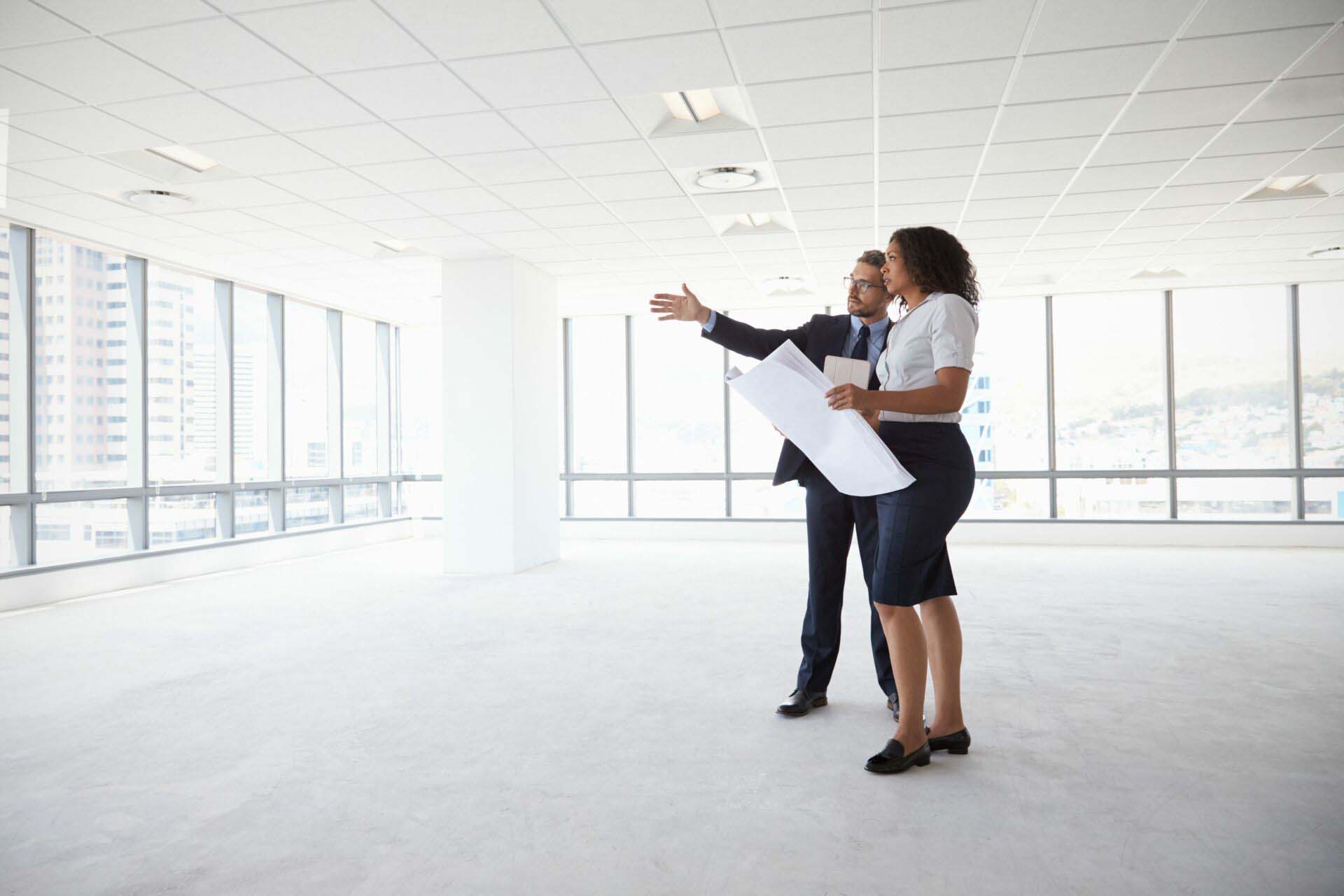 Businesspeople Meeting To Look At Plans In Empty Office Insurance for Property Managers