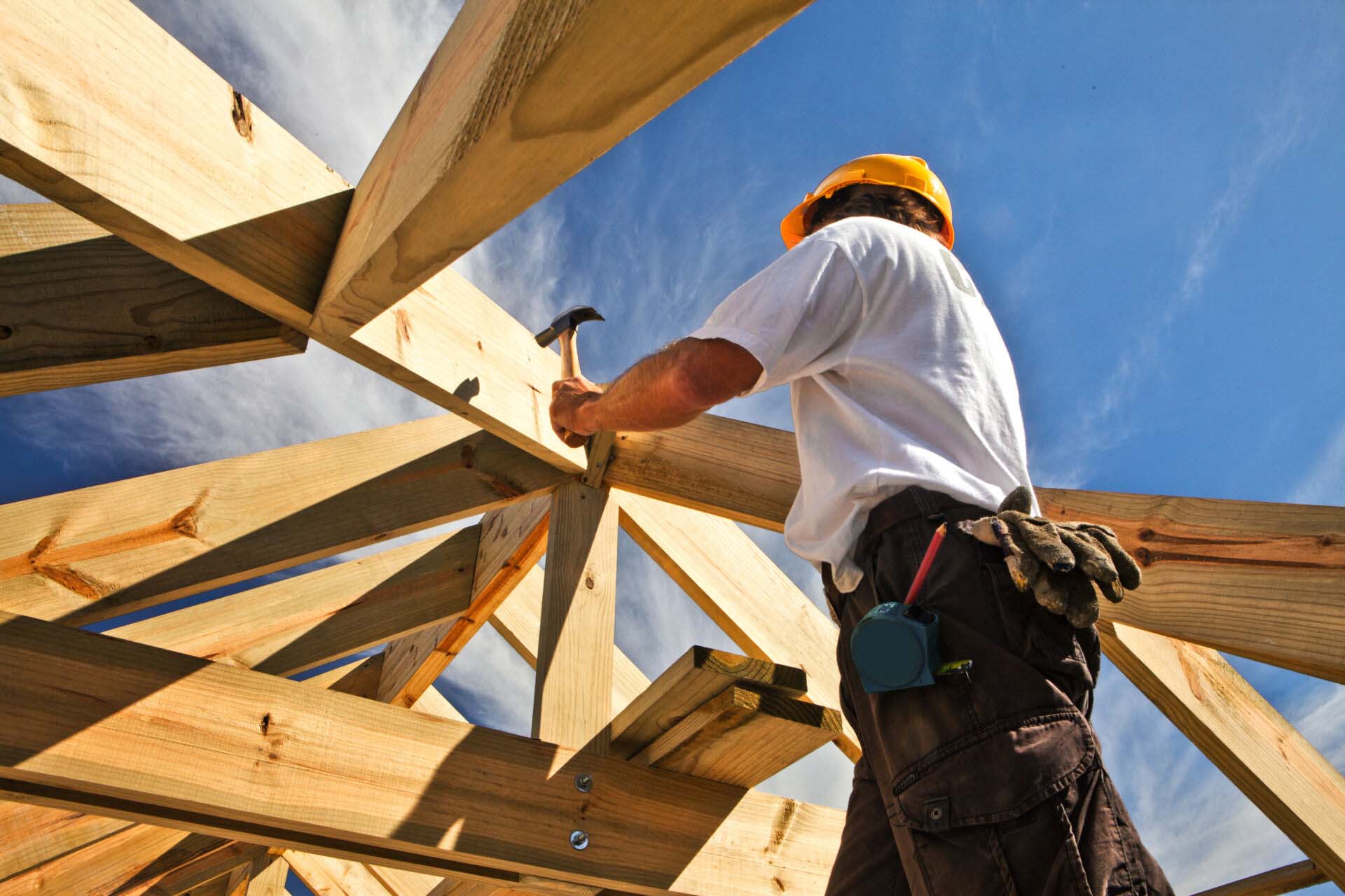 roofer ,carpenter working on roof structure at construction site Insurance for Carpenters