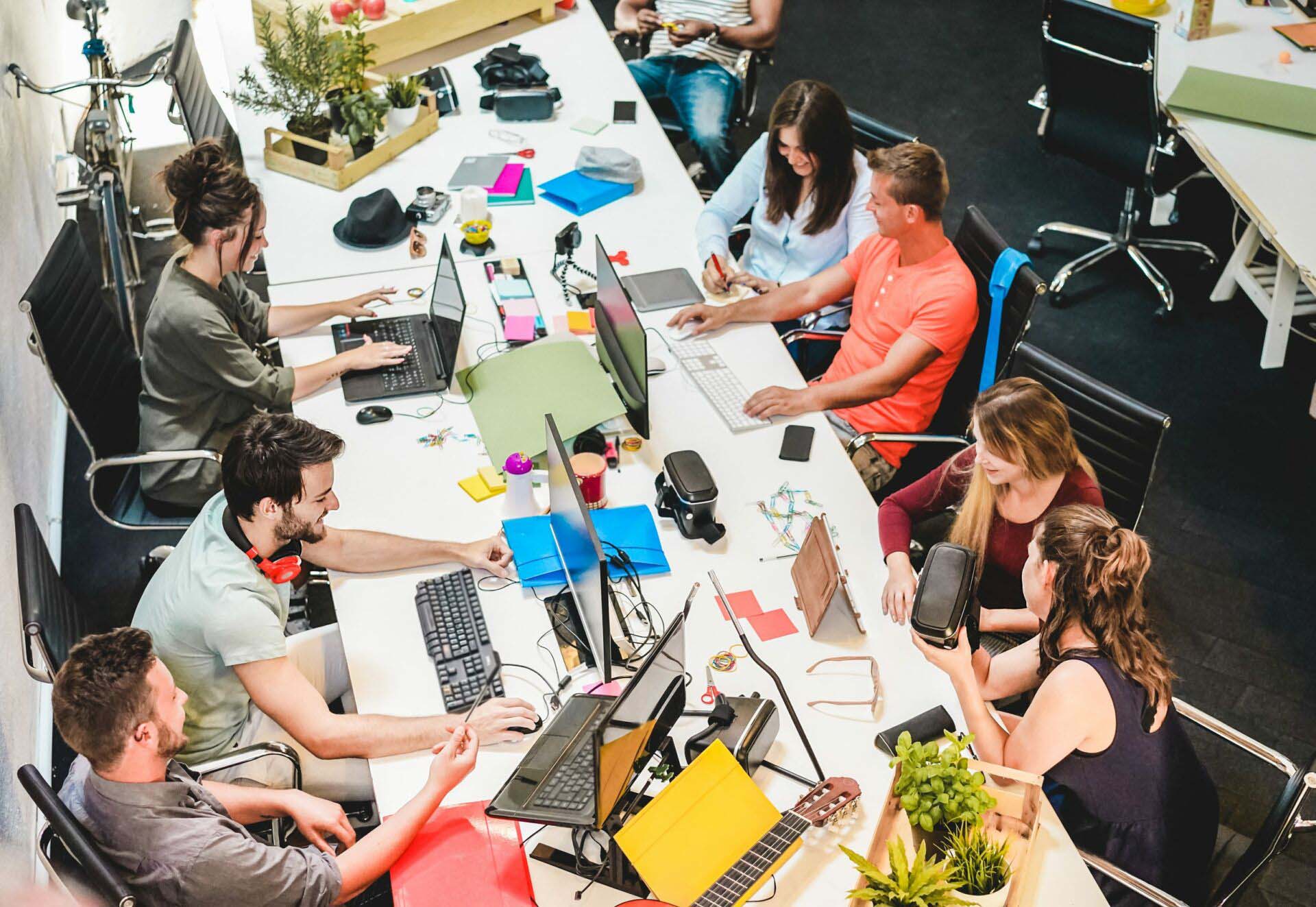Young co-workers team talking during startup – Focus on left man with headphones Insurance for Social Media Companies