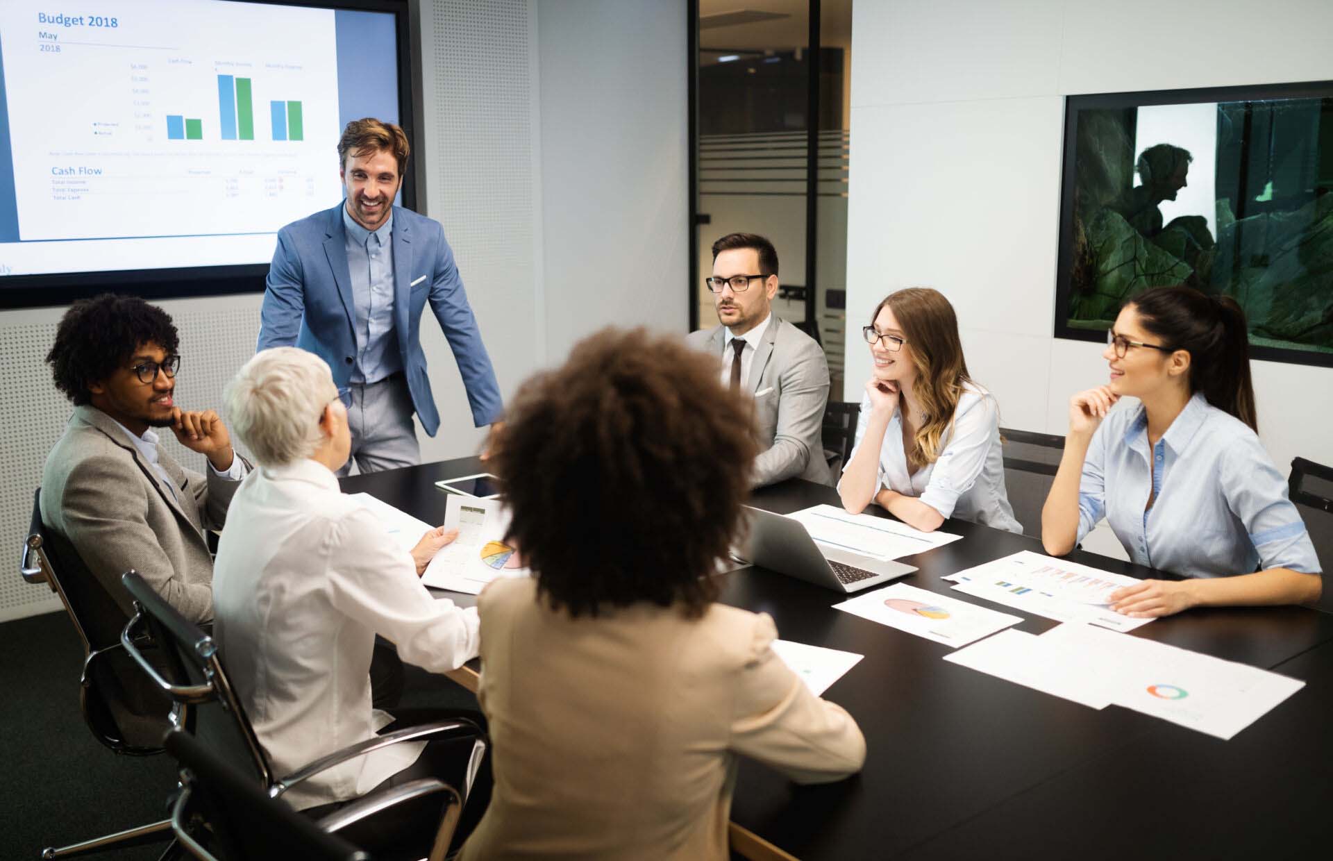 Business colleagues in conference meeting room presentation Directors & Officers Insurance