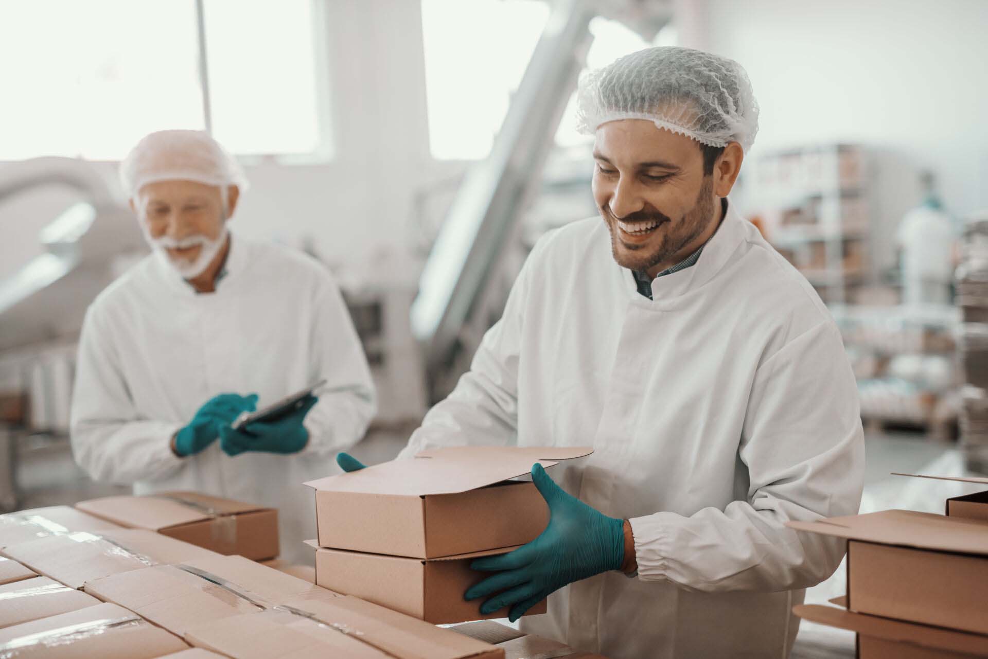 Smiling hardworking dedicated Caucasian employee arranging boxes Insurance for Food and Beverage Wholesalers