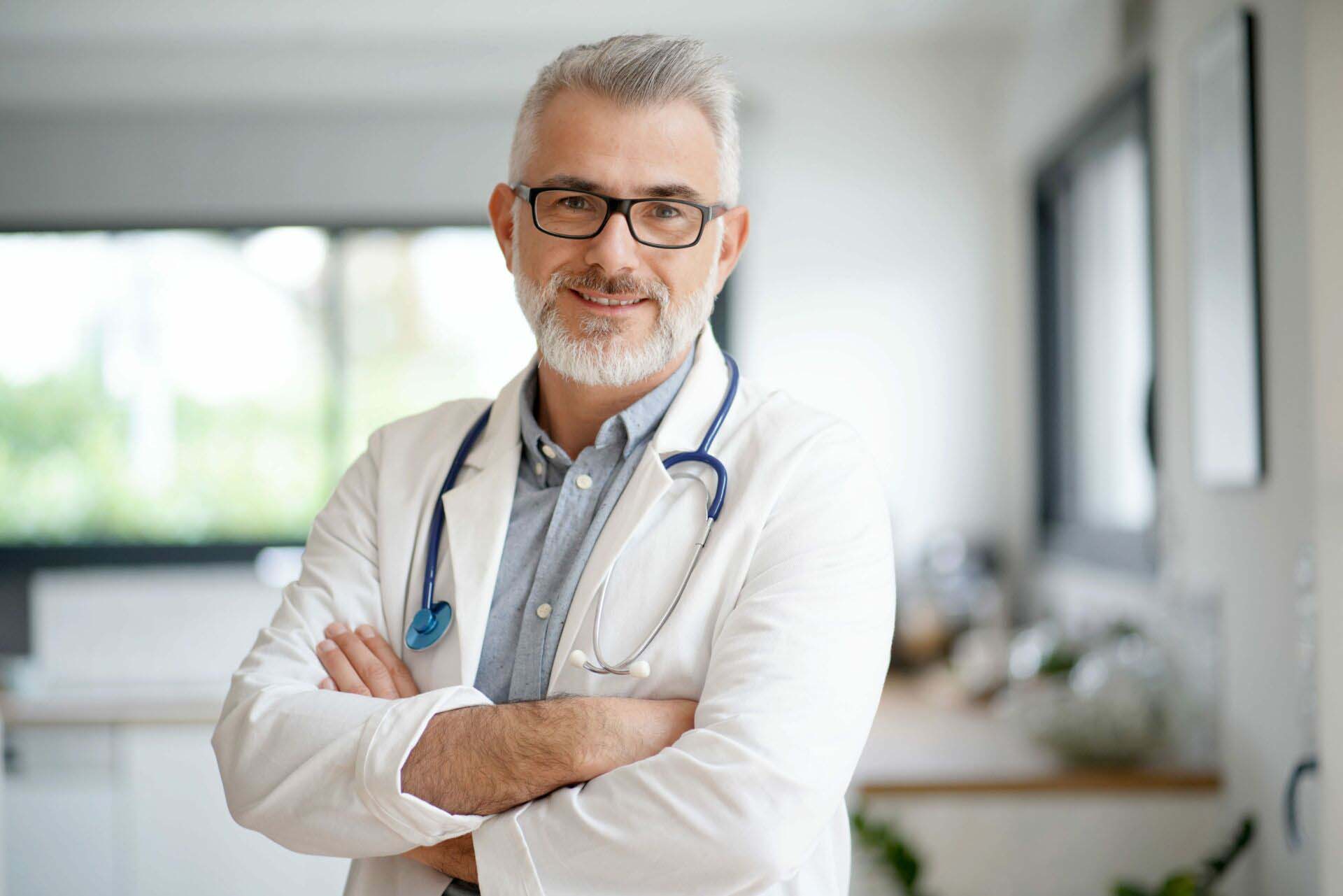 Portrait of mature doctor with eyeglasses Insurance for Doctors