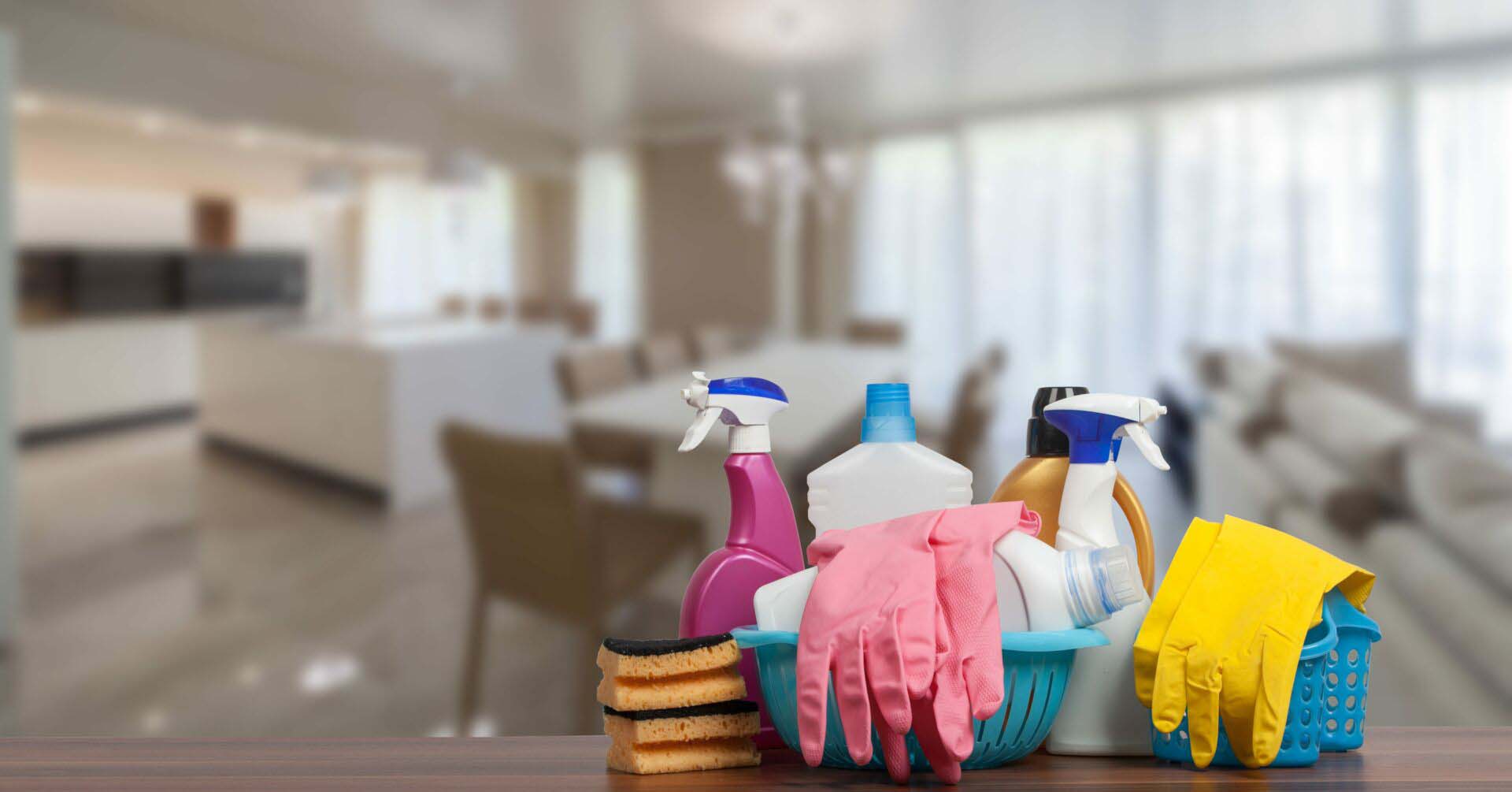 Home cleaning service concept with supplies. Close up of cleaning supplies in front of livingroom. Cleaning Services