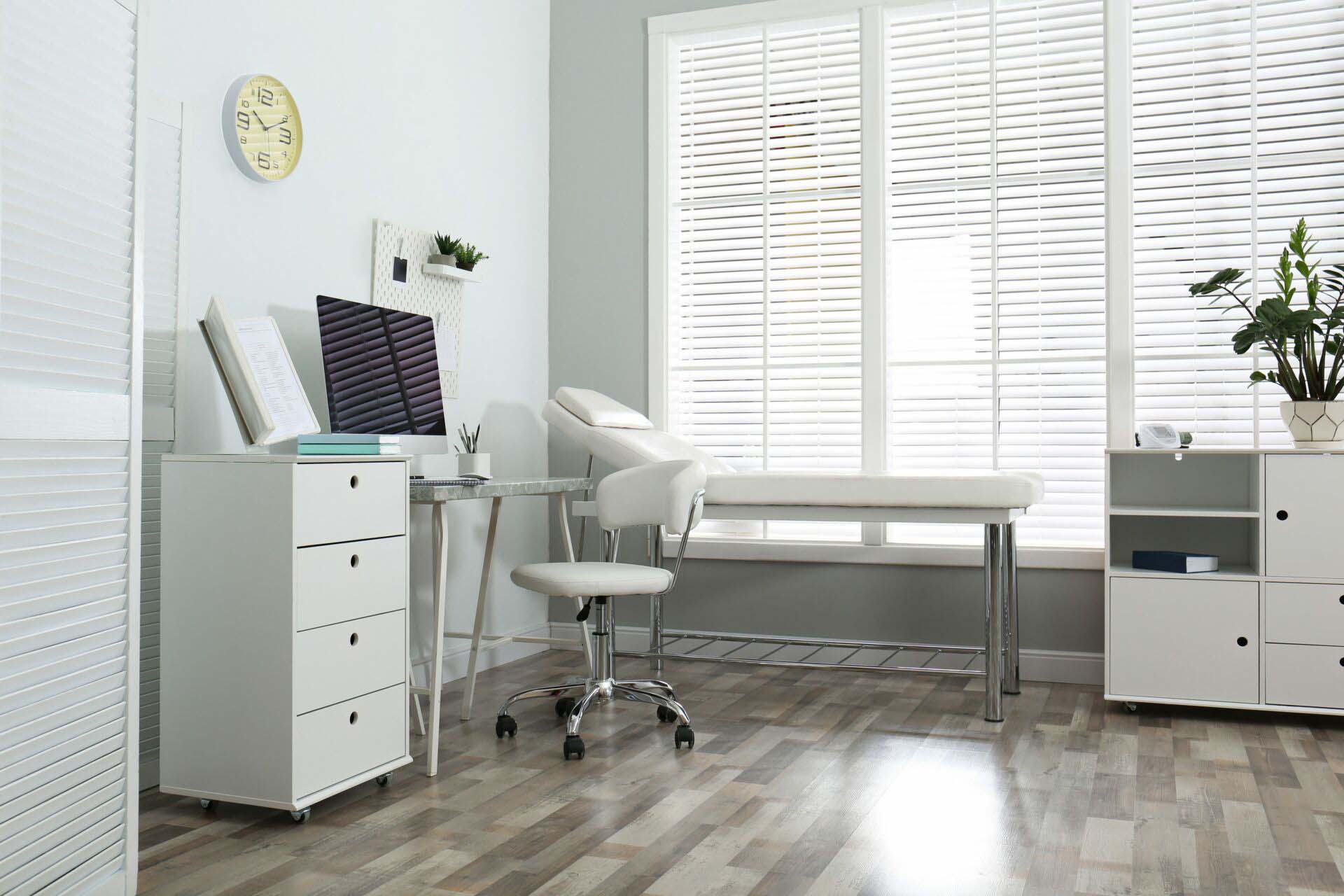 Modern medical office interior with computer and examination tab Healthcare Facilities