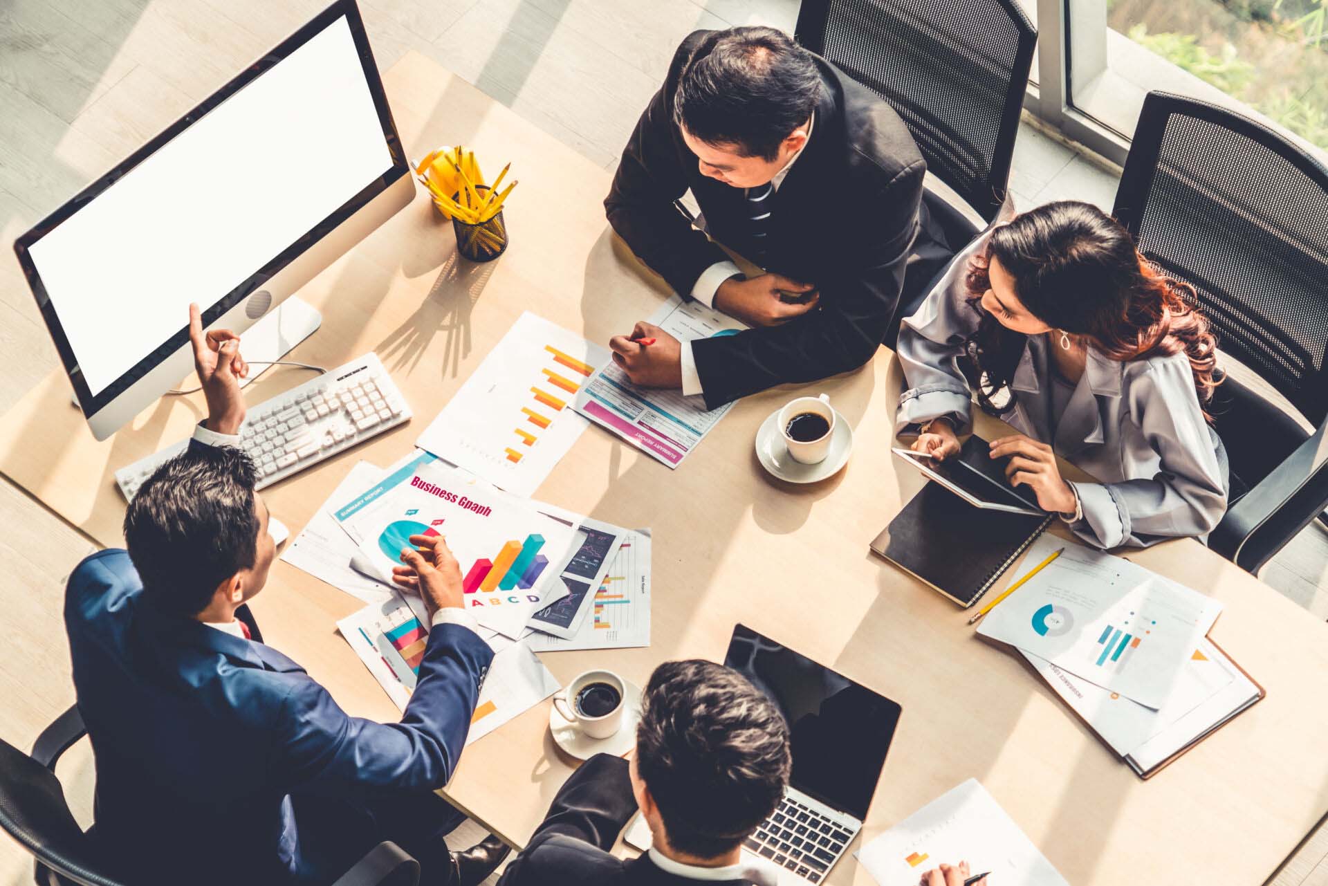 Smart businessman and businesswoman talking discussion in group meeting at office table in a modern office interior. Business collaboration strategic planning and brainstorming of coworkers. Insurance for Market Research Analysts