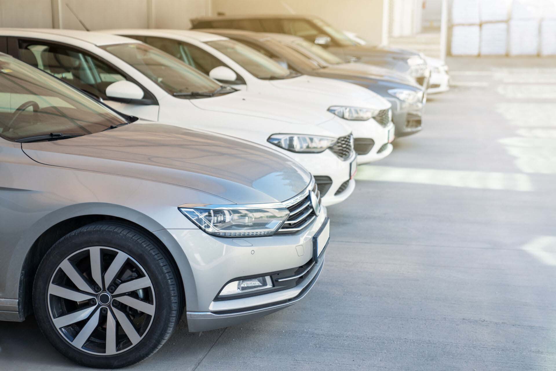 Cars in the parking lot on sunny day. Hired & Non-Owned Auto Insurance