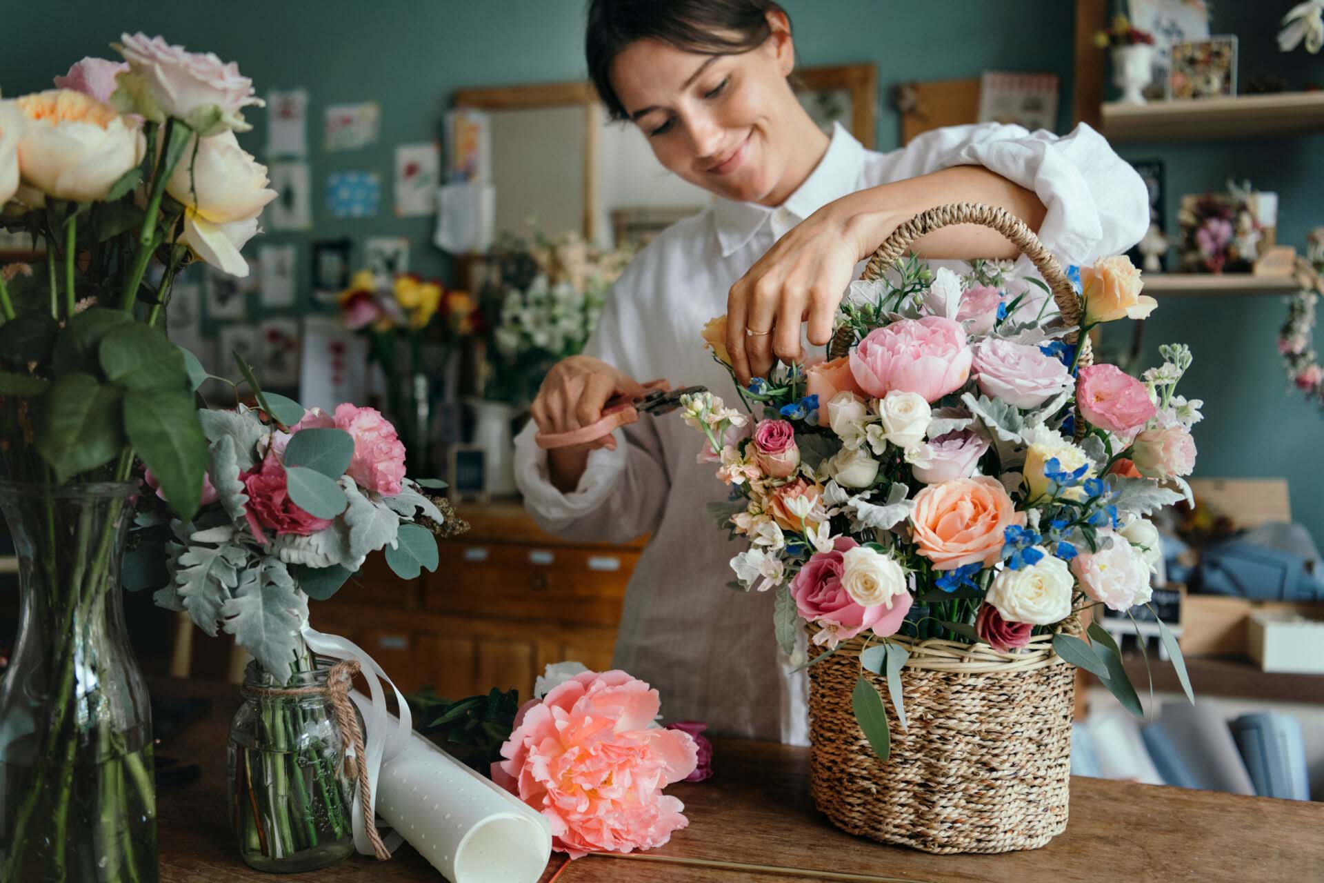 Woman arranging flowers Insurance for Floral Shops