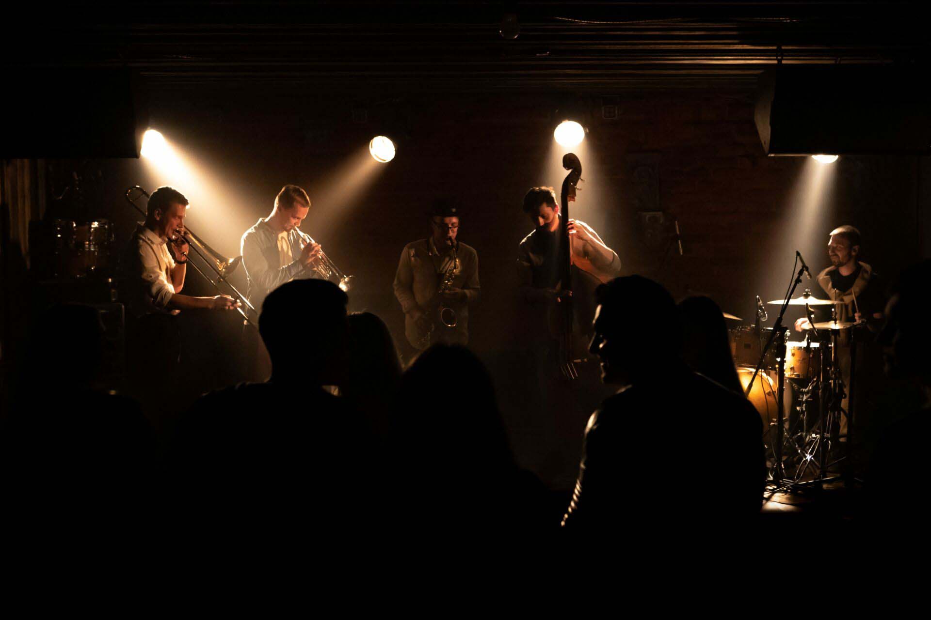 WIDE People dancing during concert of a modern jazz band playing on a stage Special Events Insurance