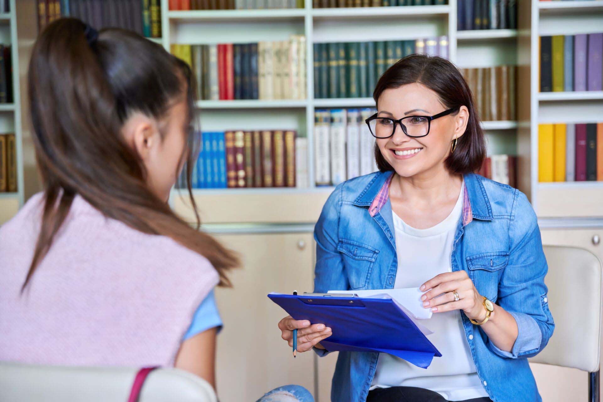 Woman school psychologist, teacher, social worker, mentor working with teenage girl Insurance for Health Educators