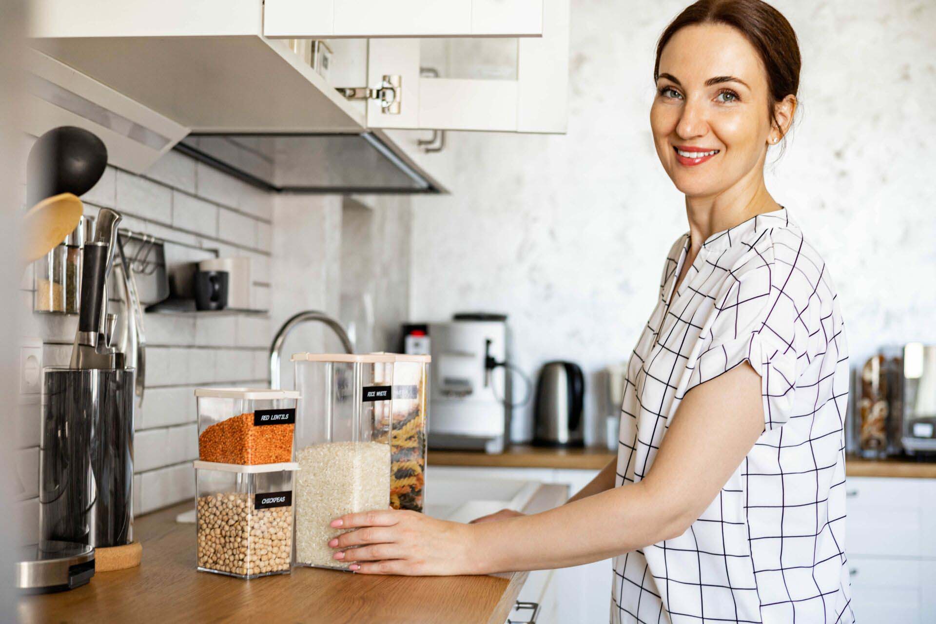Woman professional space organizer smiling posing with case boxes for comfortable product storage Insurance for Professional Organizers