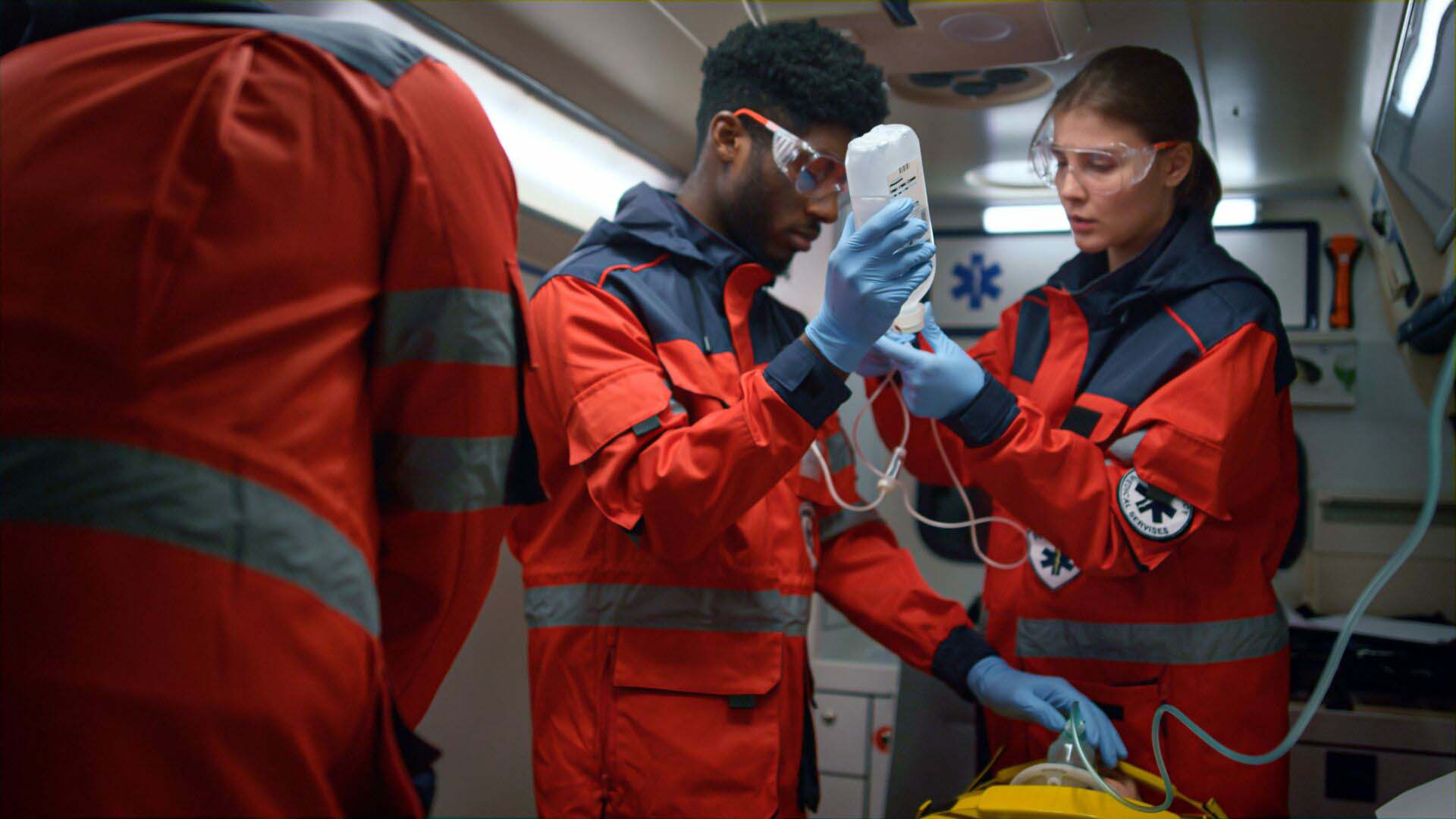 Professional paramedics performing first aid procedure in emergency car Insurance for EMTs and Paramedics