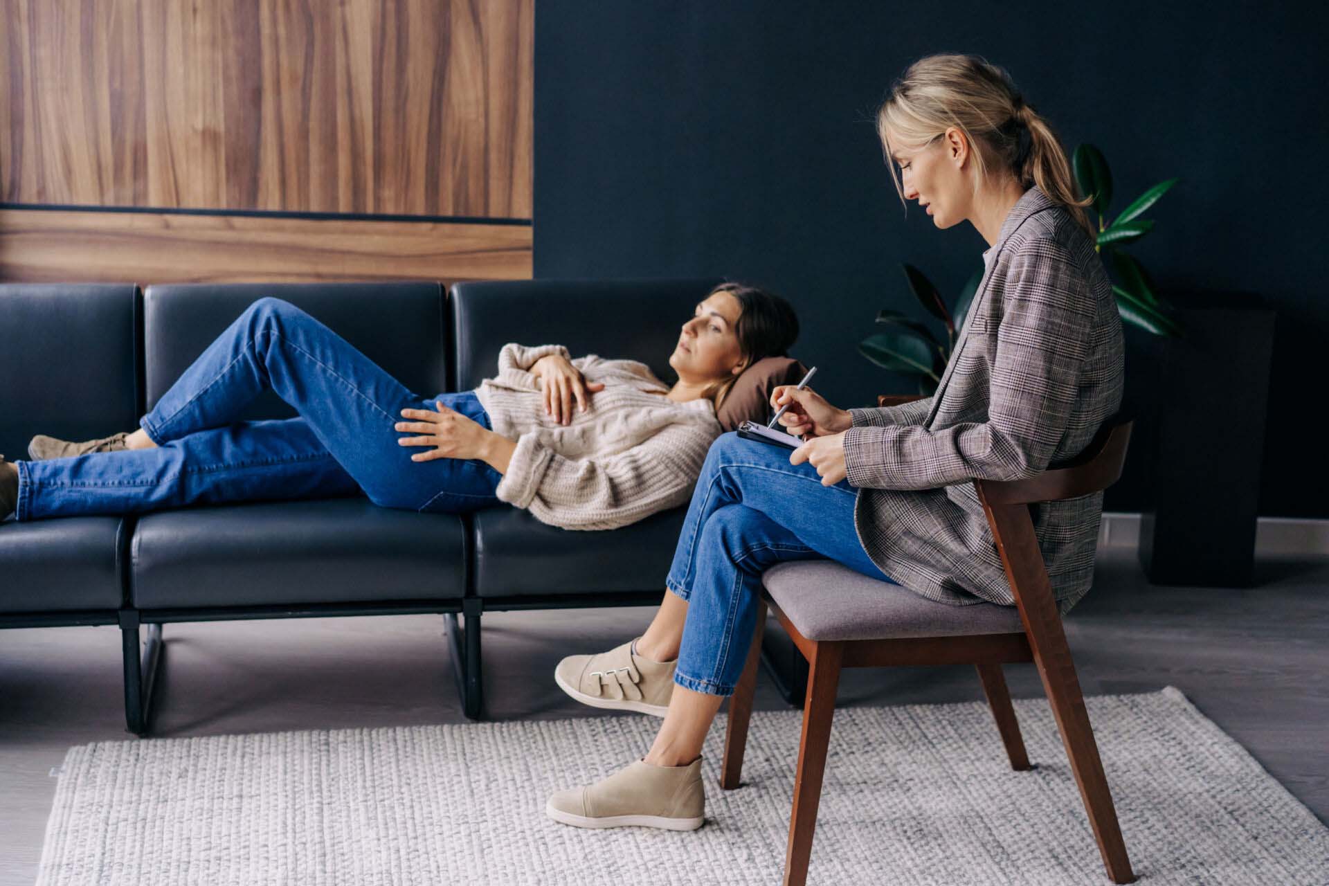Woman lying on couch talking about problems to therapist Insurance for Psychologists