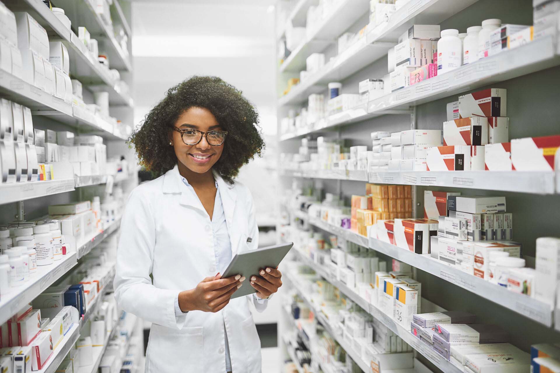 We have all the medication anybody would ever need. Portrait of a cheerful young female pharmacist standing with a digital tablet while looking at the camera in a pharmacy. Insurance for Pharmacies and Drugstores