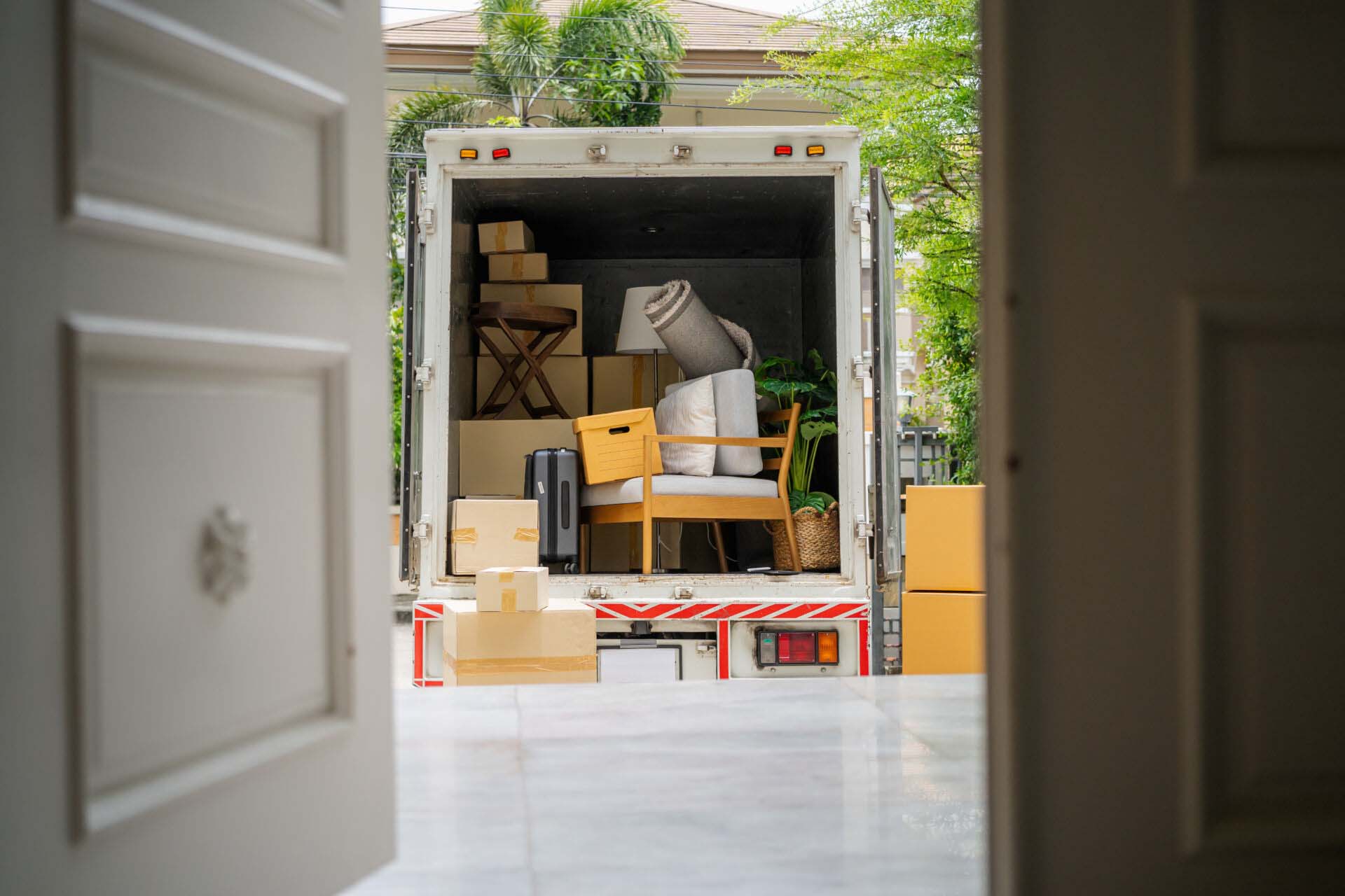 back of a truck carrying goods moving house Insurance for Moving Companies