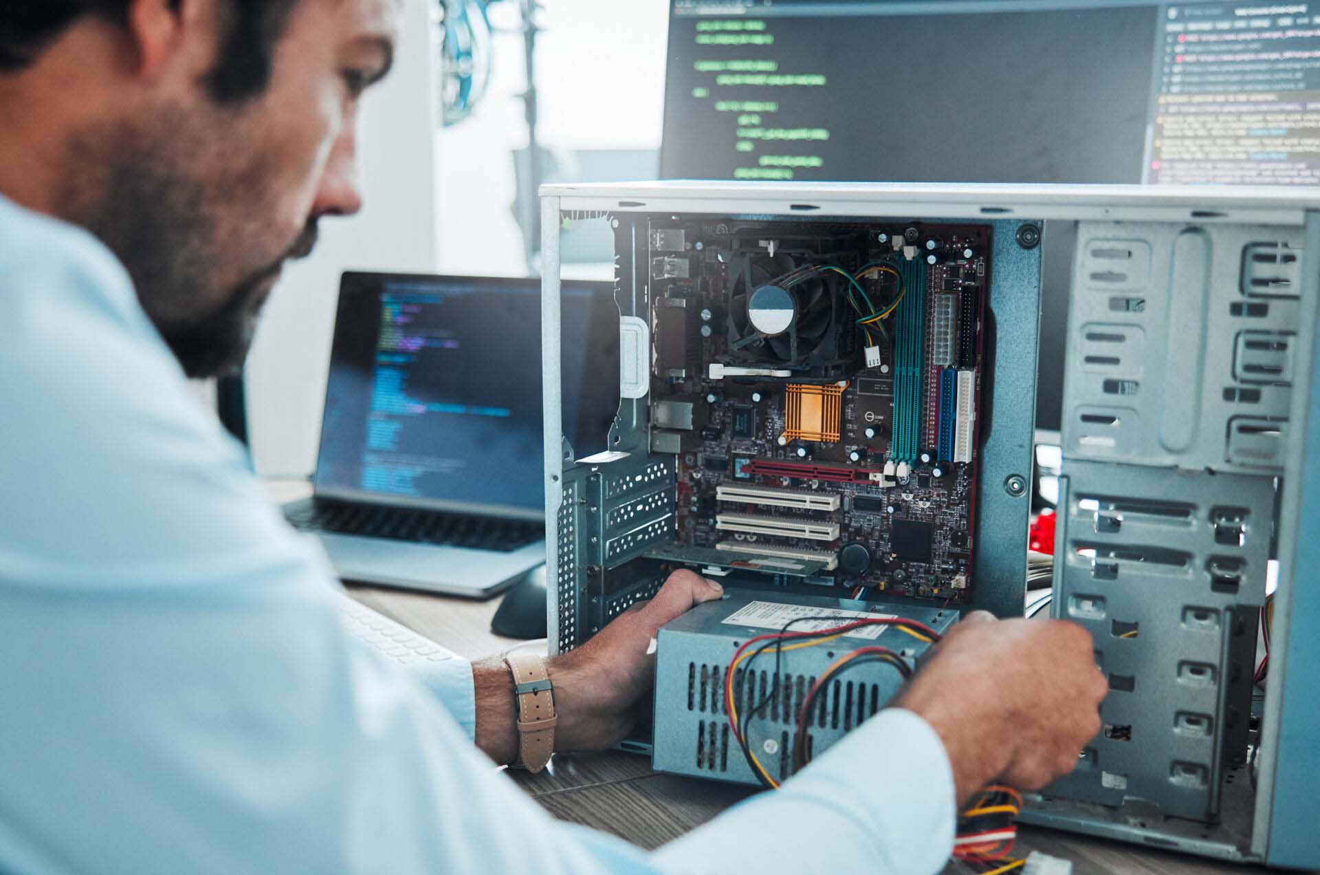 It technician, engineer and computer hardware with a man working to fix or maintenance technology. Hands of expert IT person in office data center for system repair, engineering or motherboard update Insurance for PC Builders