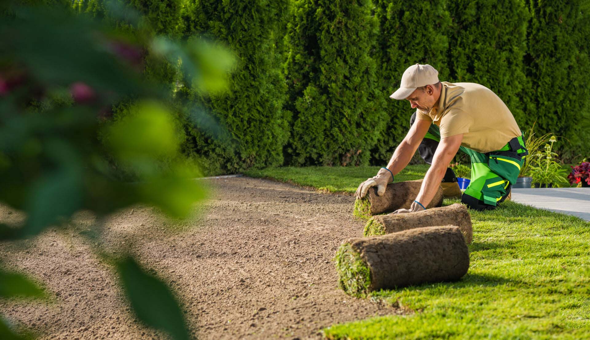 Caucasian Landscaping Worker Installing New Lawn Made From Natural Grass Turfs Insurance for Lawn Care Businesses