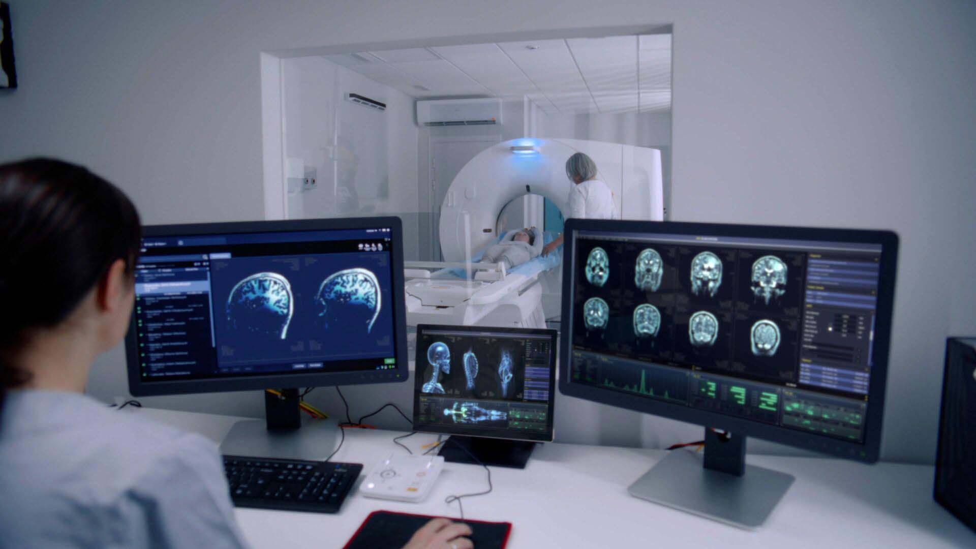 Female radiologist sits in control room and watches at monitors Insurance for Radiologists