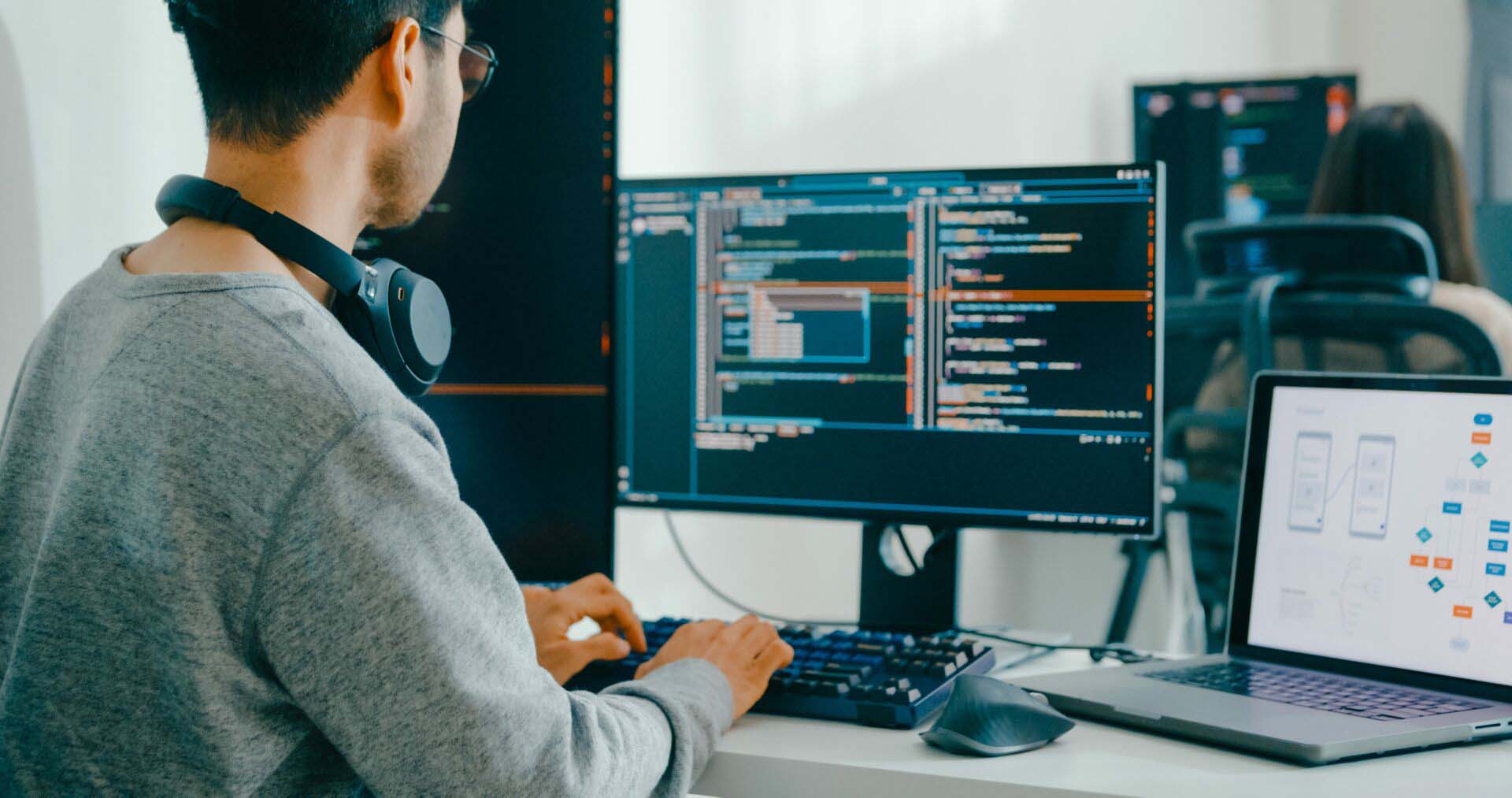 Closeup Adult Asia male, female freelance typing write prompt AI bot IT app smart program nomad, video game, terminal with coding language, user interface, designer, big data center desktop computer. Insurance for App Developers