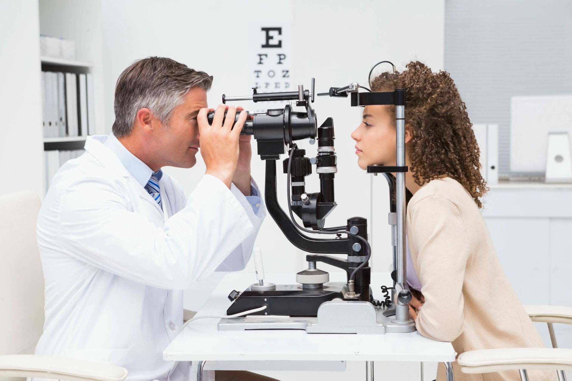 Woman doing eye test with optometrist Insurance for Optometrists