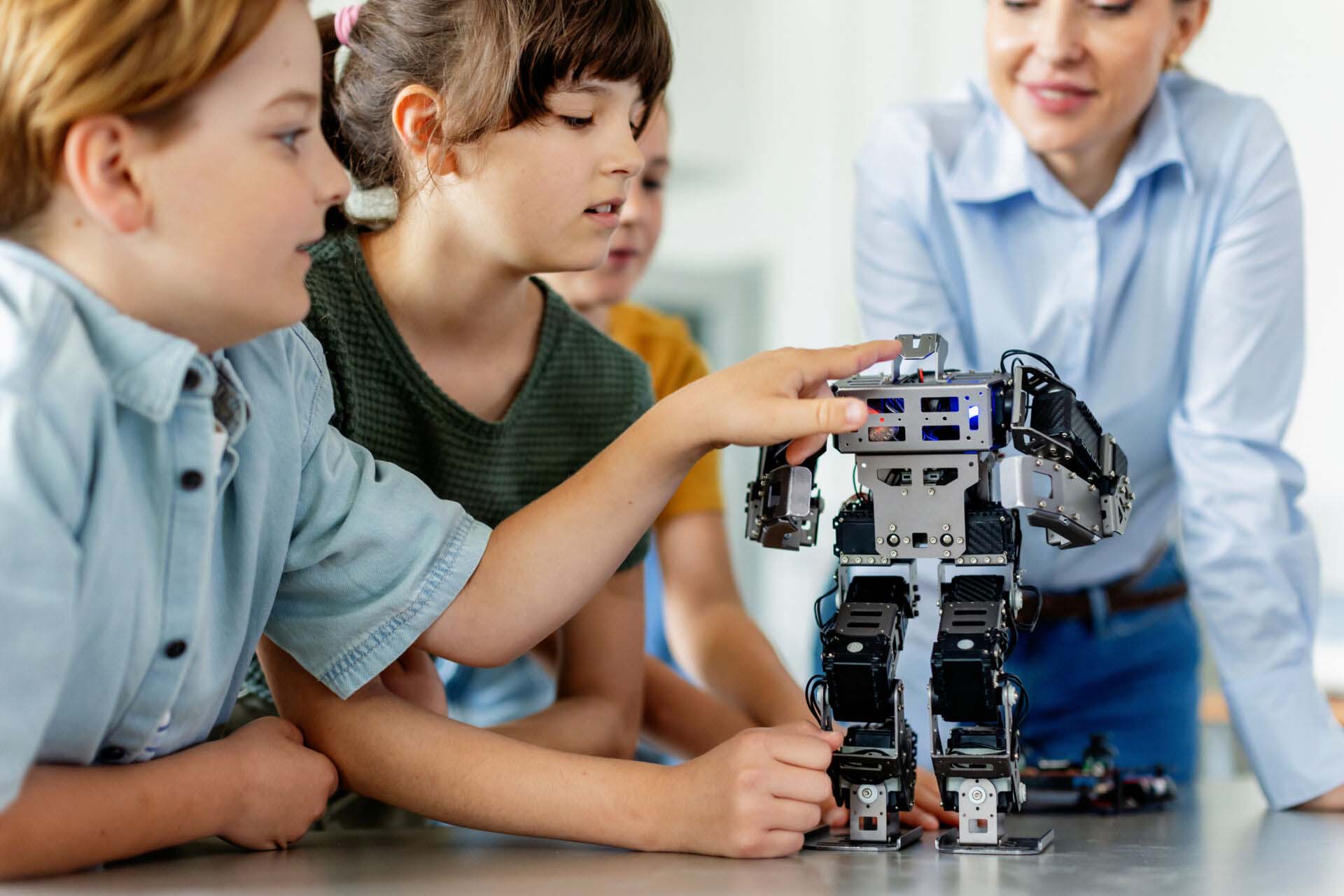 Children learning robotics in Elementary school. Young students building robot in after school robotics club. Field trip to real robotics laboratory. Insurance for After-School Programs