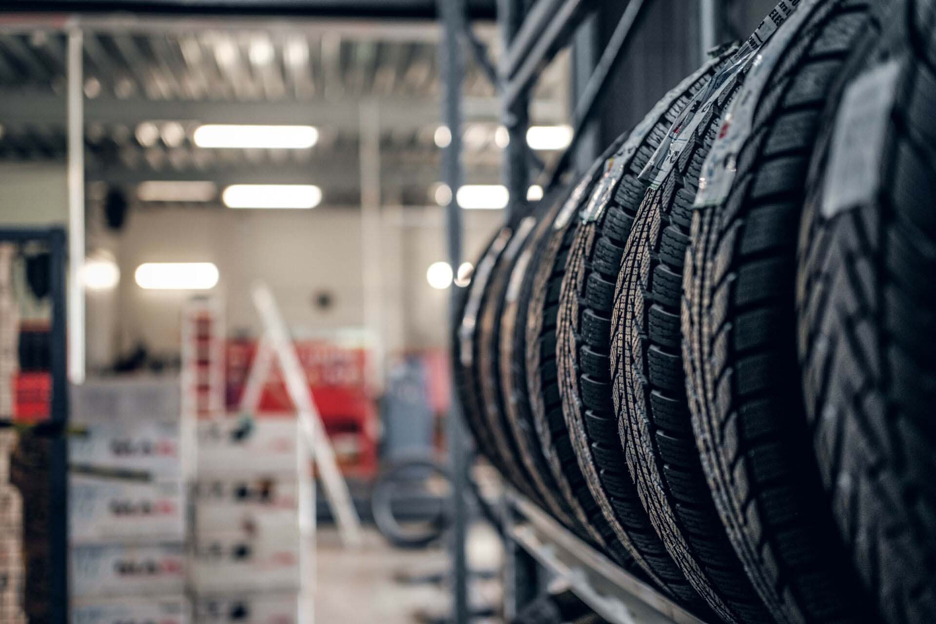 Variety of tyres at busy warehouse Insurance for Tire Shops