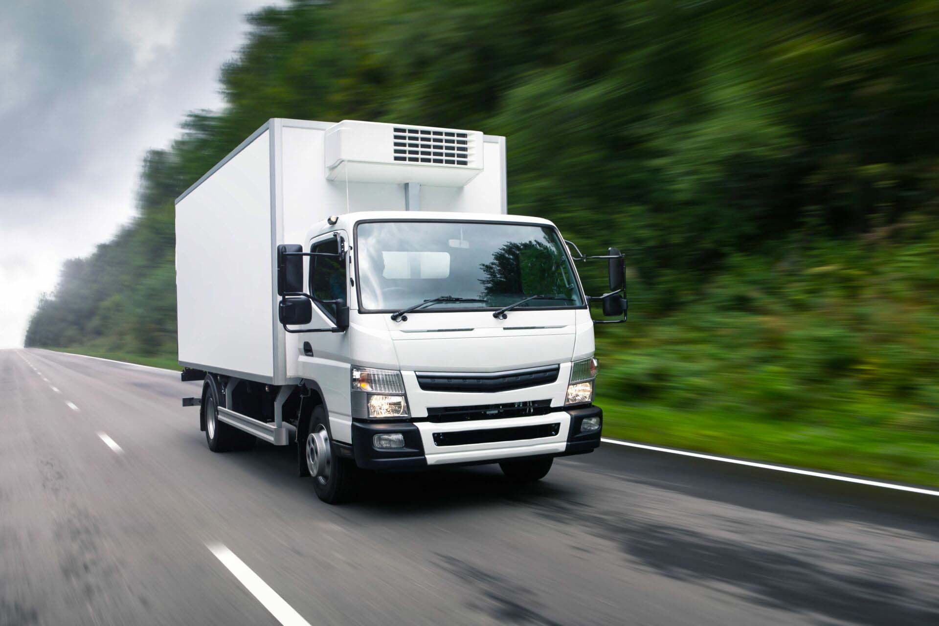 Cargo truck moving on road. Concept: cargo road transportation, Insurance for Cannabis Transporters