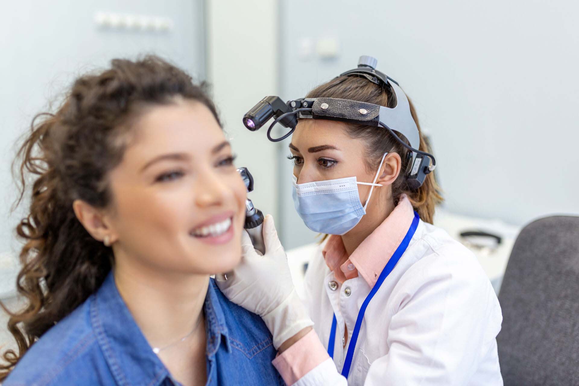 Hearing exam for a woman. Diagnosis of impairment and hearing testing in adults. Patient woman during an ear check-up with an audiologist Insurance for Audiologists