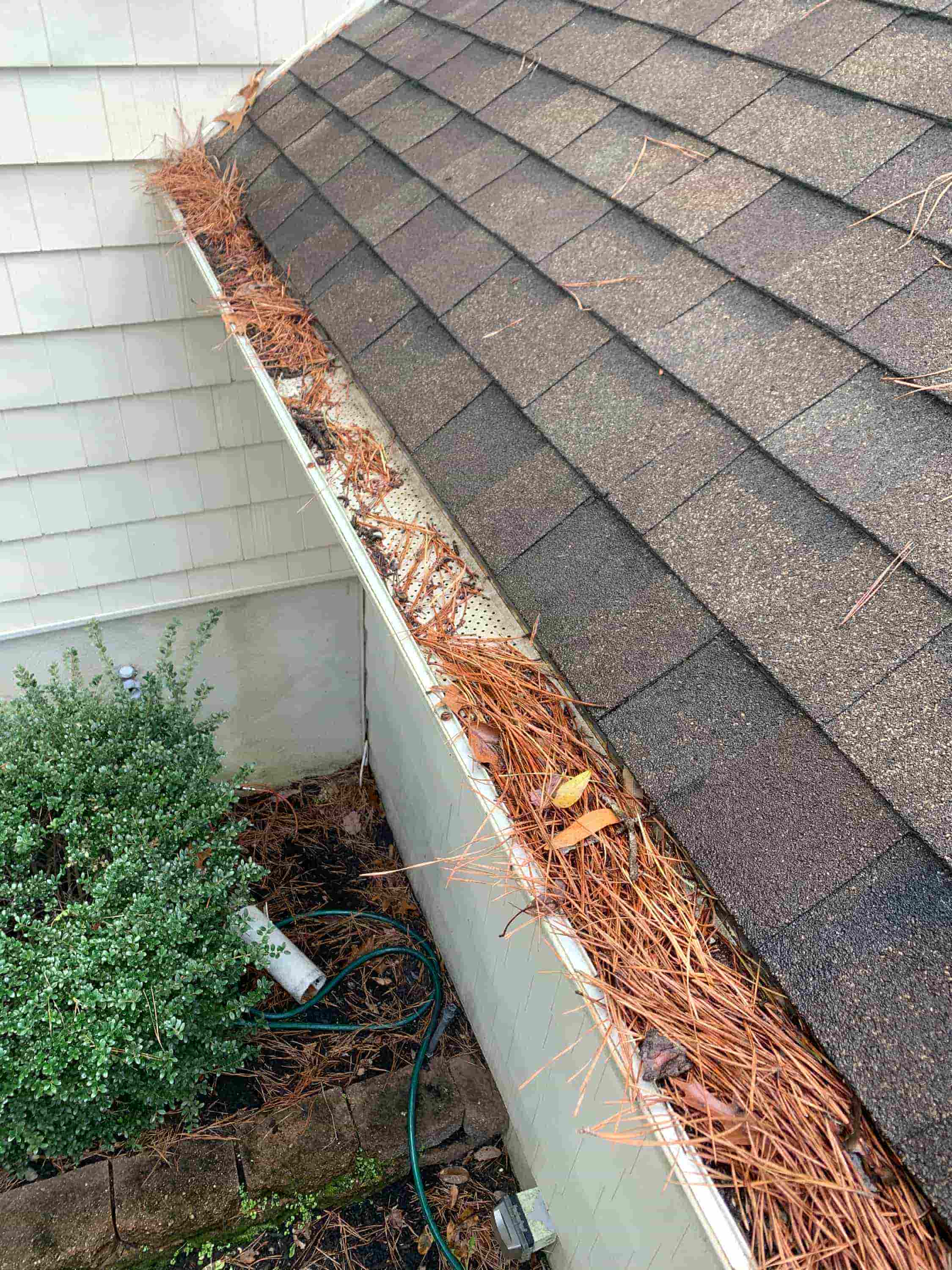 cleaning downspouts from ground