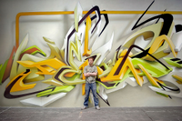 German artist DAIM in front a unique 3D-style piece of graffiti art