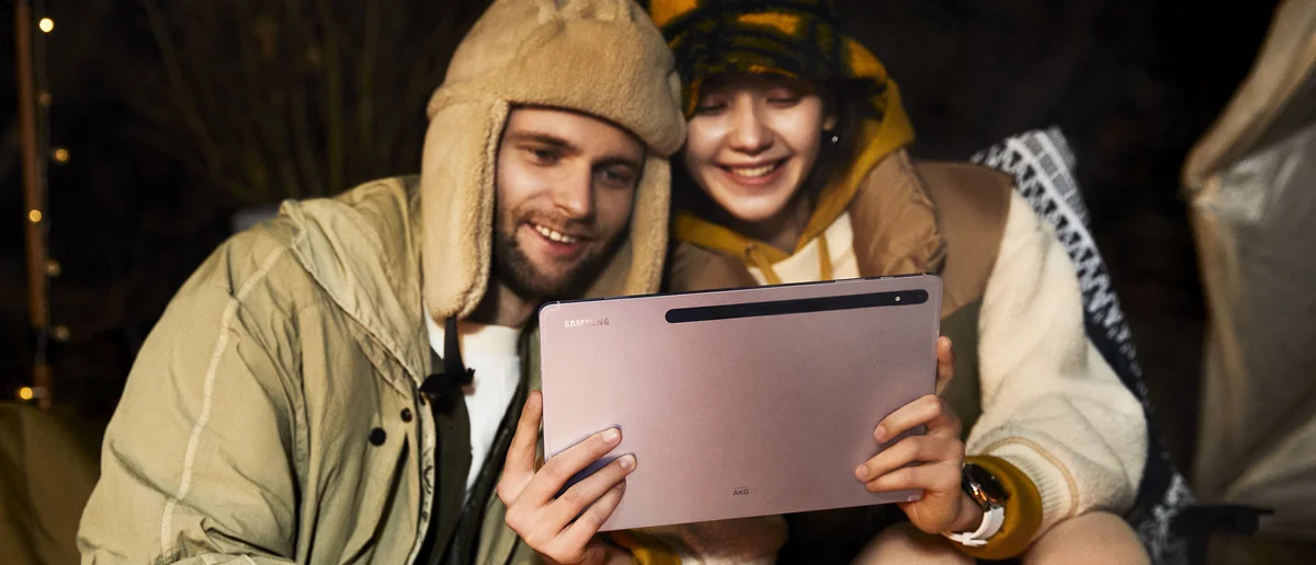 A couple holding and looking at a Galaxy Tab S8 series device.