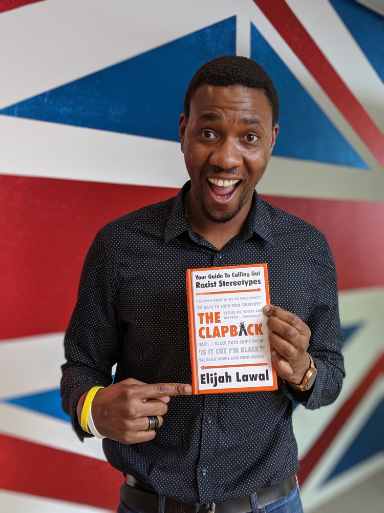 Elijah Lawal poses with his book